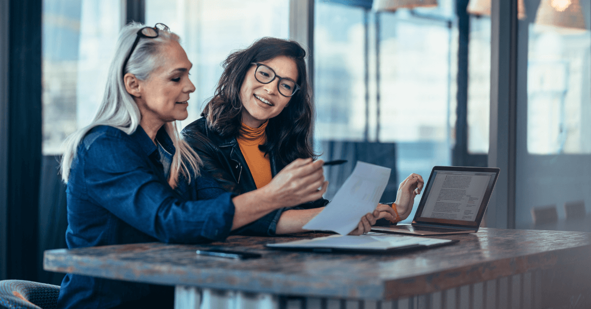 Two colleagues analyzing documents together