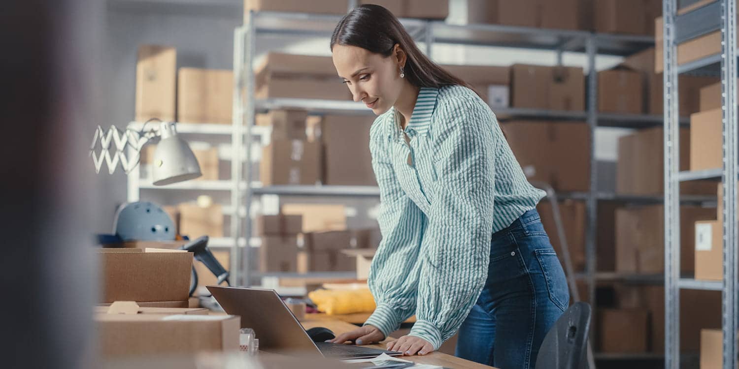 woman working on a retail contract on a laptop