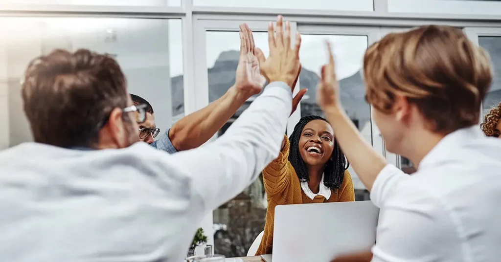 Business team high five and celebrate for team success