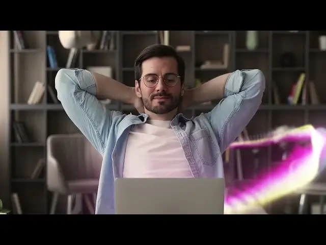 Relaxed man wearing glasses and denim shirt leans back with hands behind head in front of a laptop, with a pink-yellow digital wave beside him.