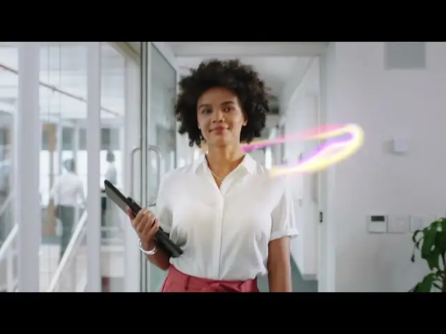 Confident woman walking through a bright office hallway holding a laptop, with a colorful swoosh graphic floating beside her.