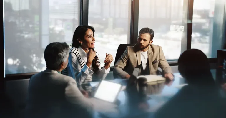 Team of professionals engaged in a strategic meeting, discussing AI policy frameworks for legal teams and enterprise-wide business users.